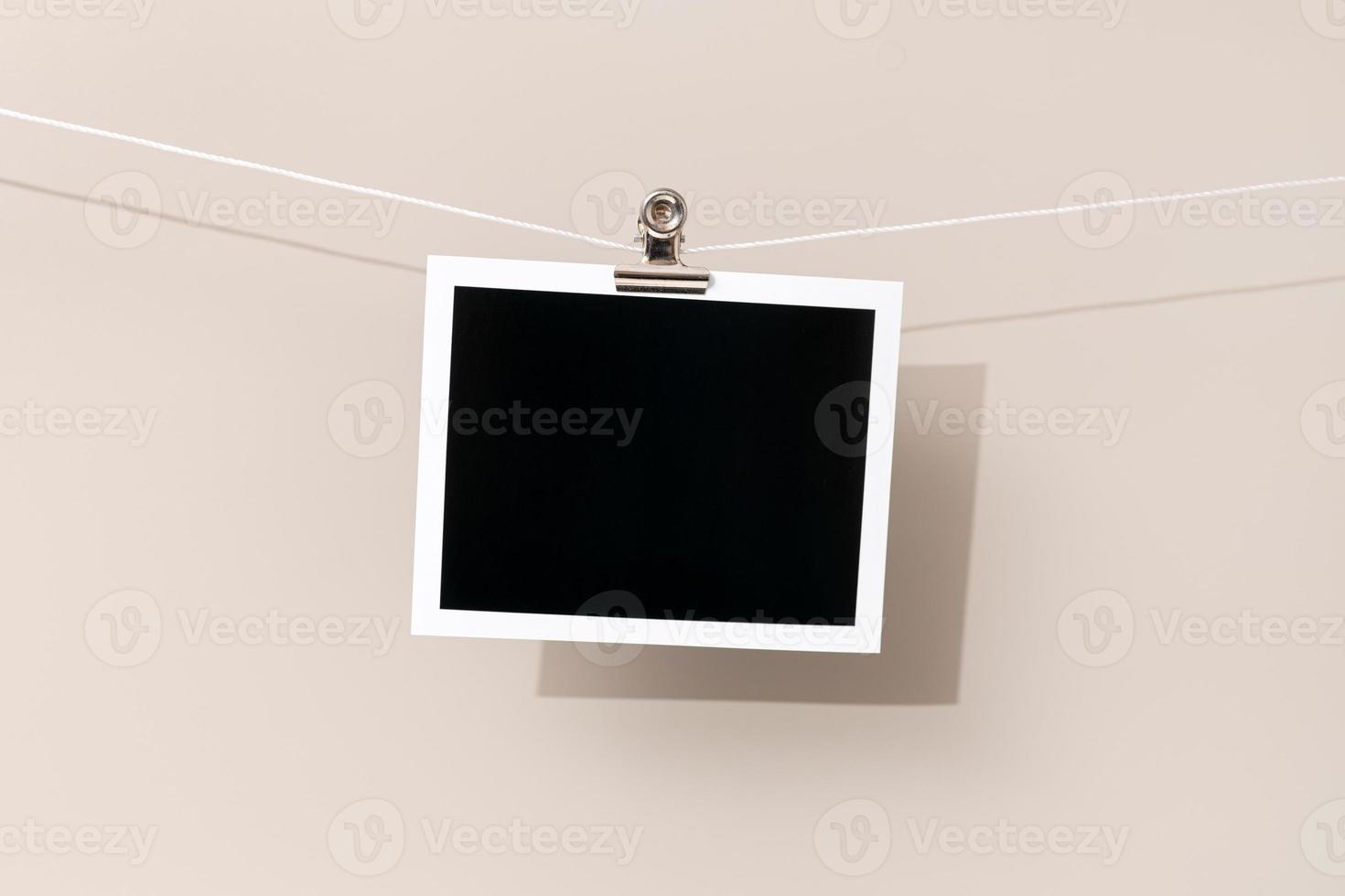 Blank Vintage instant photo frame hanging on a rope. Template