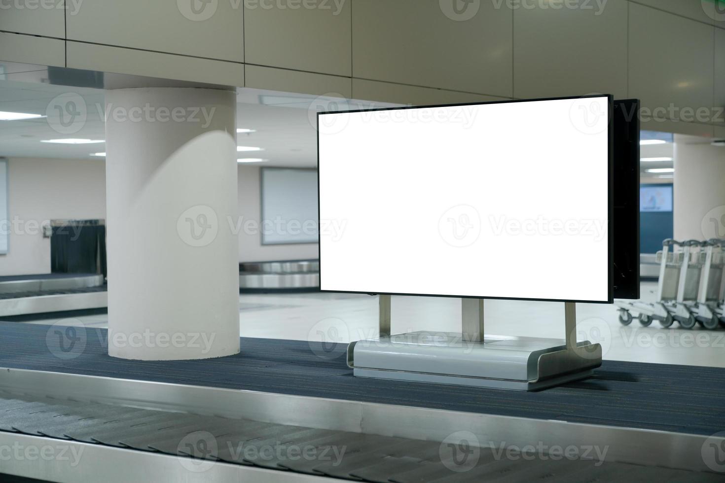 Mockup blank screen at conveyor belt luggage in airport. White screen for text advertise. photo