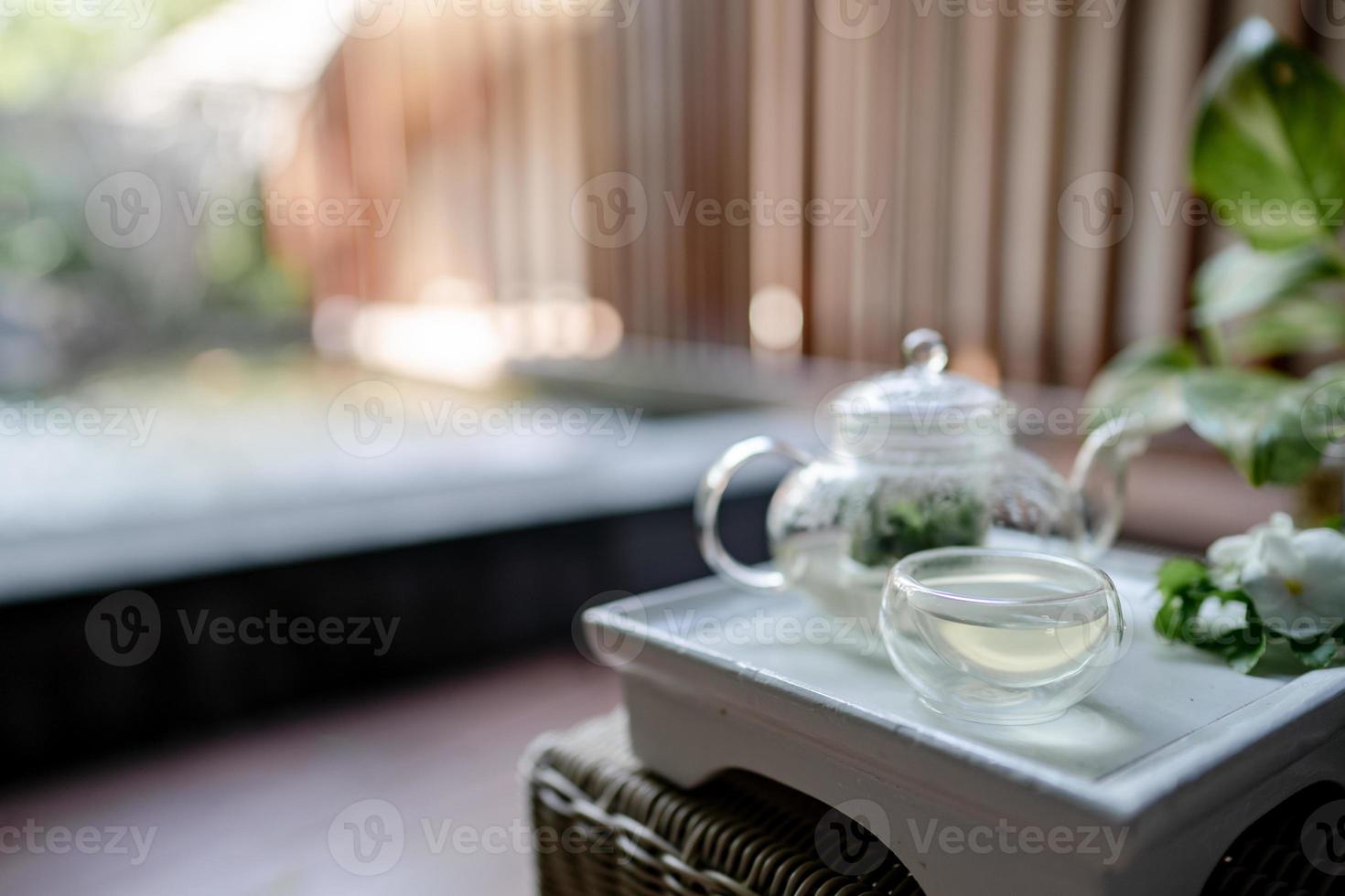 The tray of transparent teapot with herbal tea. photo