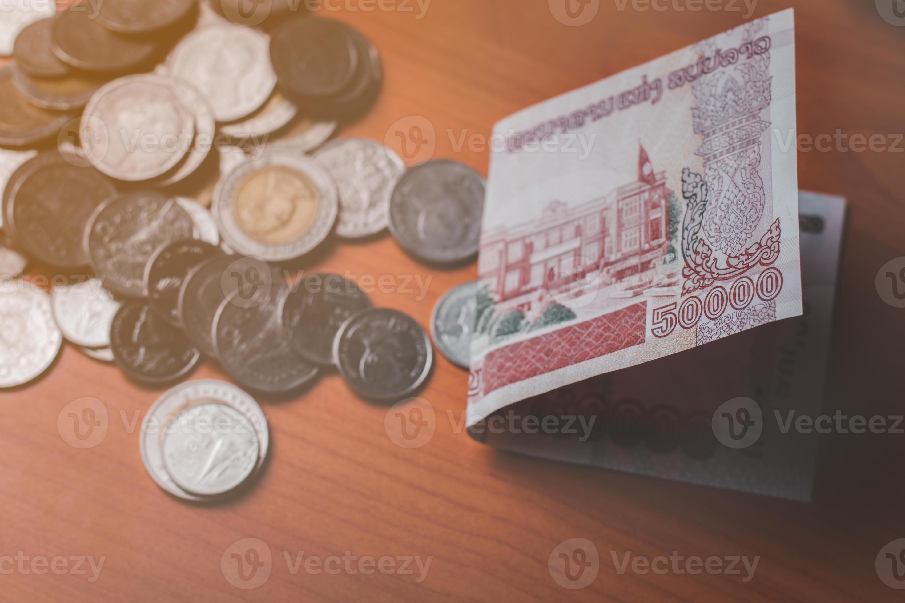 Closeup Shot Of Lao KIP Currency And Thai Baht Coin Exchange And closeup-shot-of-lao-kip-currency-and-thai-baht-coin-exchange-and