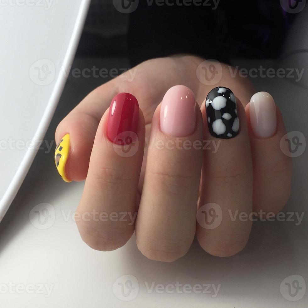 Woman with flesh-colored manicure with design, close up photo