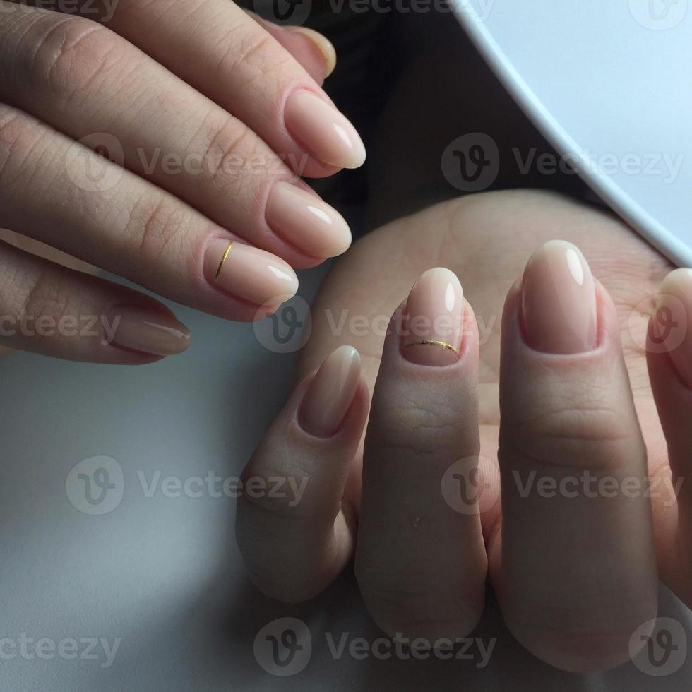 Stylish trendy female pink manicure.Hands of a woman with pink manicure on nails photo