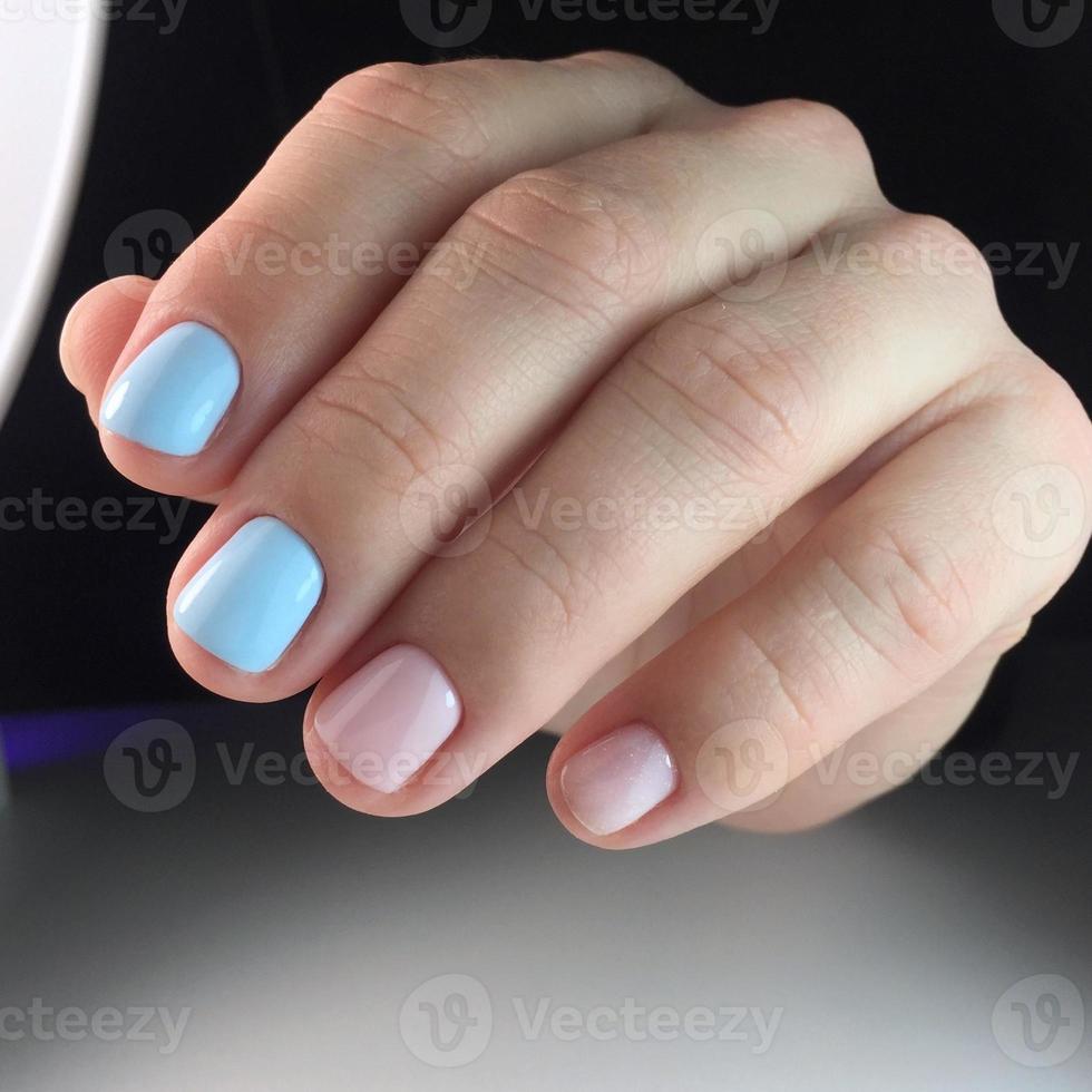 Woman with flesh-colored manicure with design, close up photo