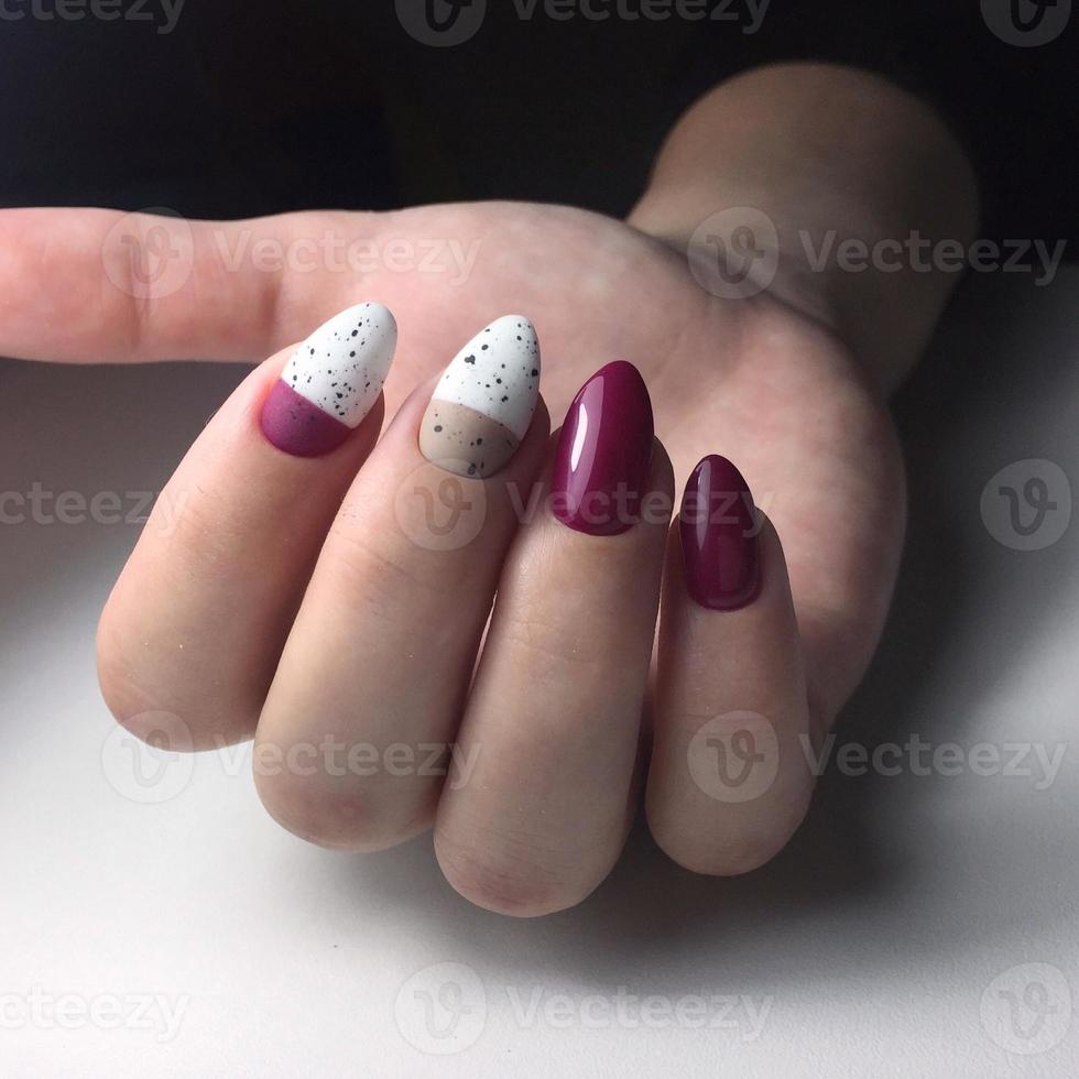 Woman with flesh-colored manicure with design, close up photo