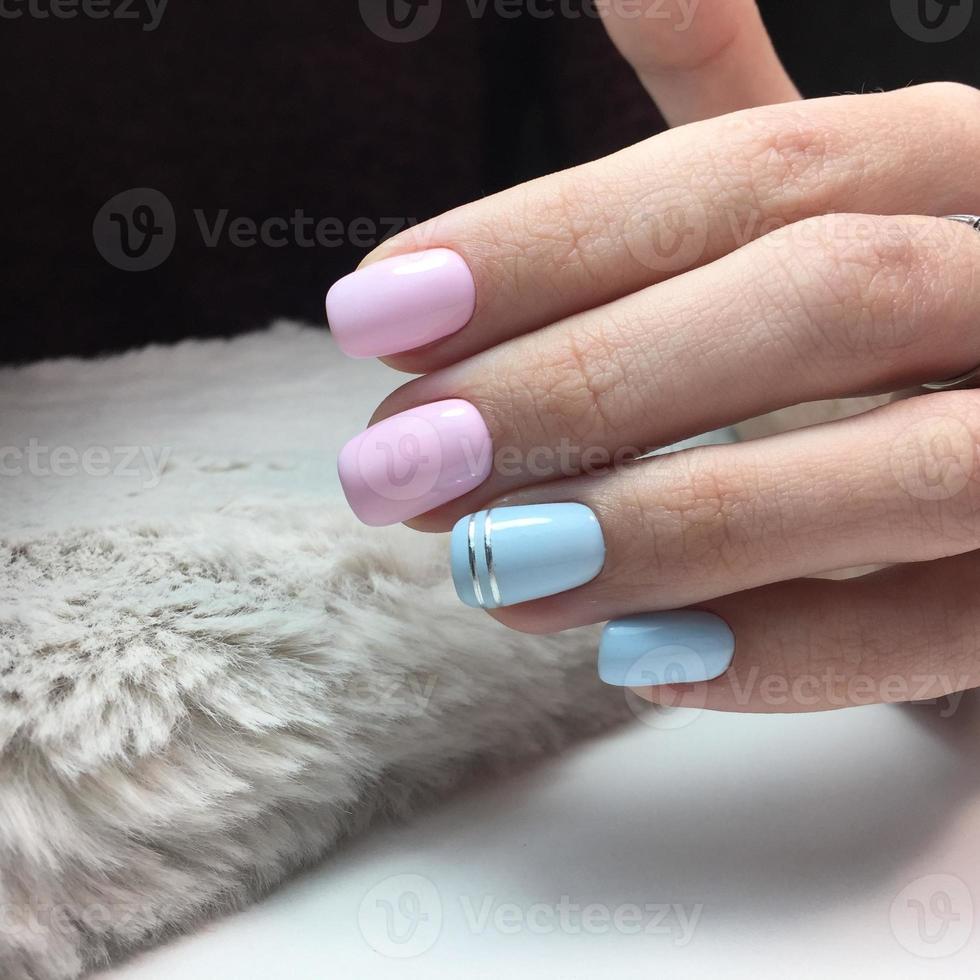 Woman with flesh-colored manicure with design, close up photo