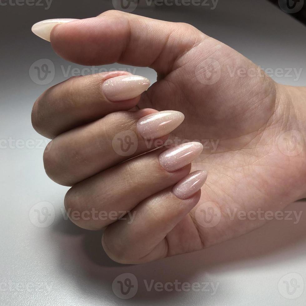 Solid manicure on girl nails with gel polish photo