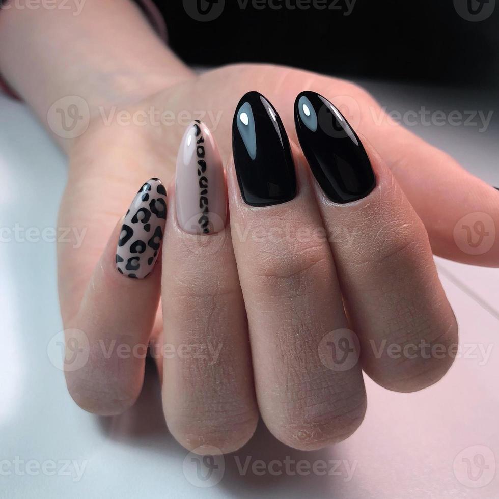 Woman with stylish black manicure on background, closeup photo