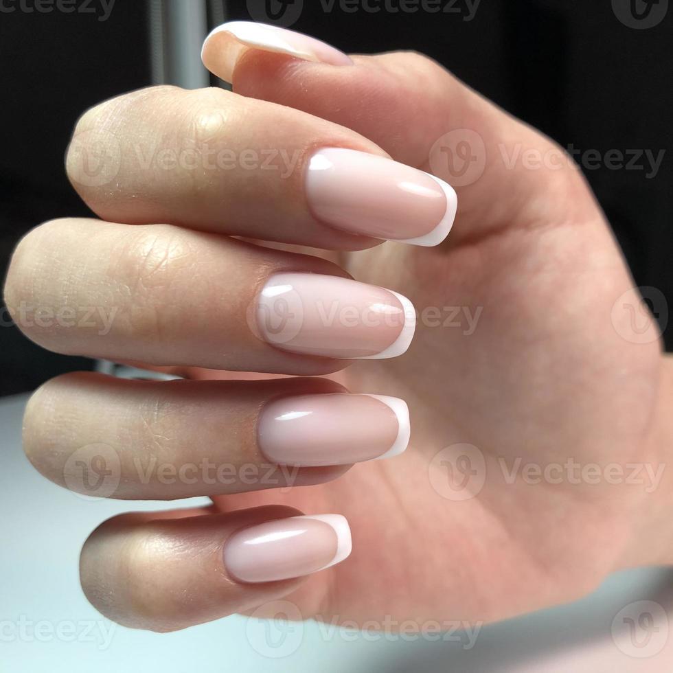 French manicure on the nails. French manicure design. Manicure gel nail polish photo