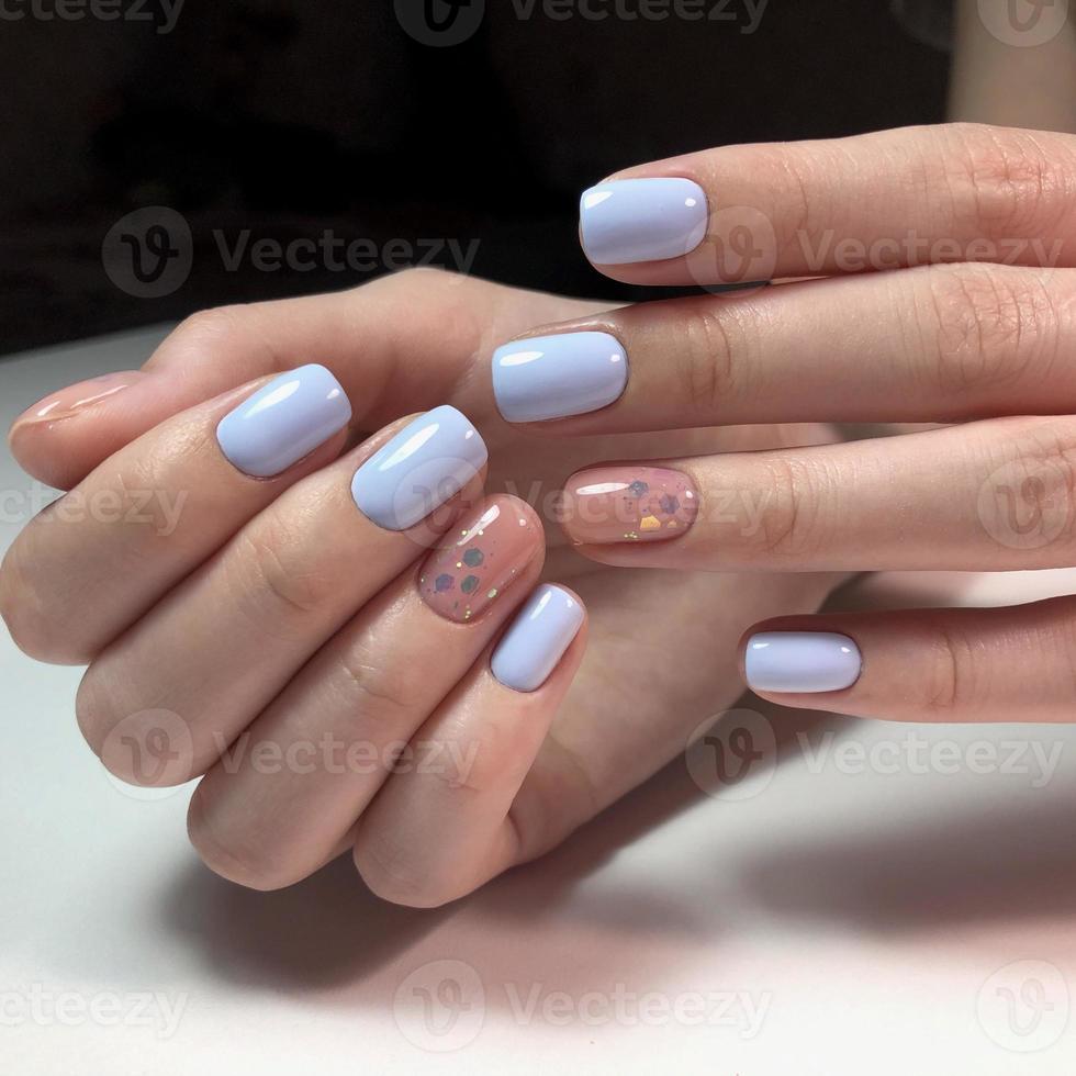 Woman with flesh-colored manicure with design, close up photo