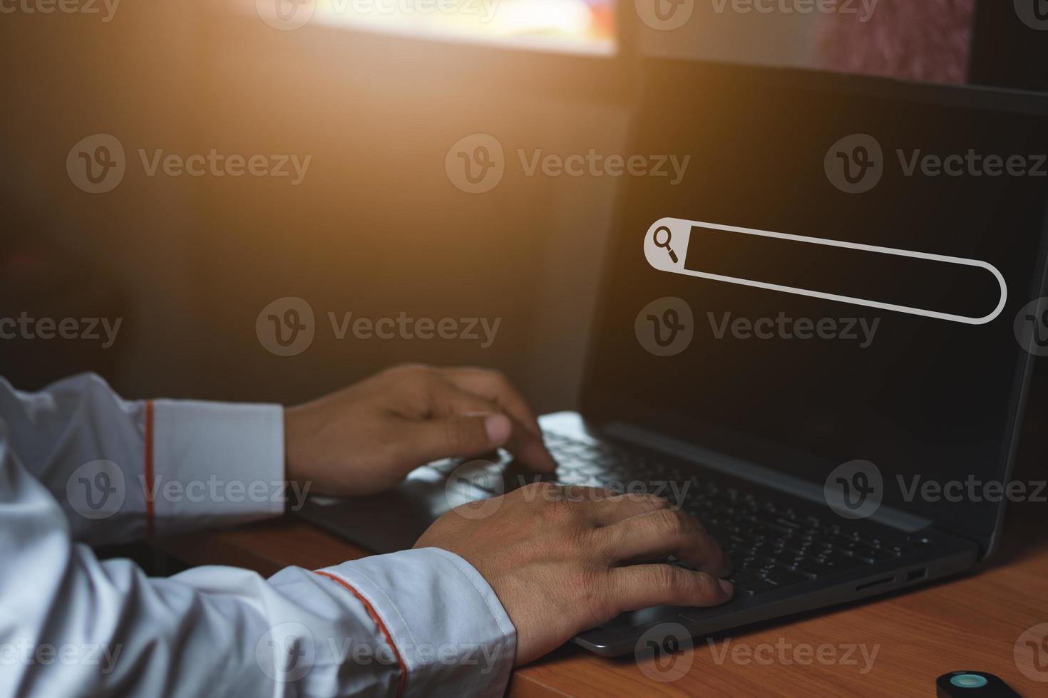 Search informationA business man in the office, using laptop for searching information on the internet, computer and search technology concept photo