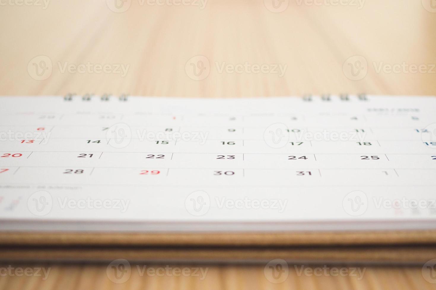 calendar page on wood table background photo