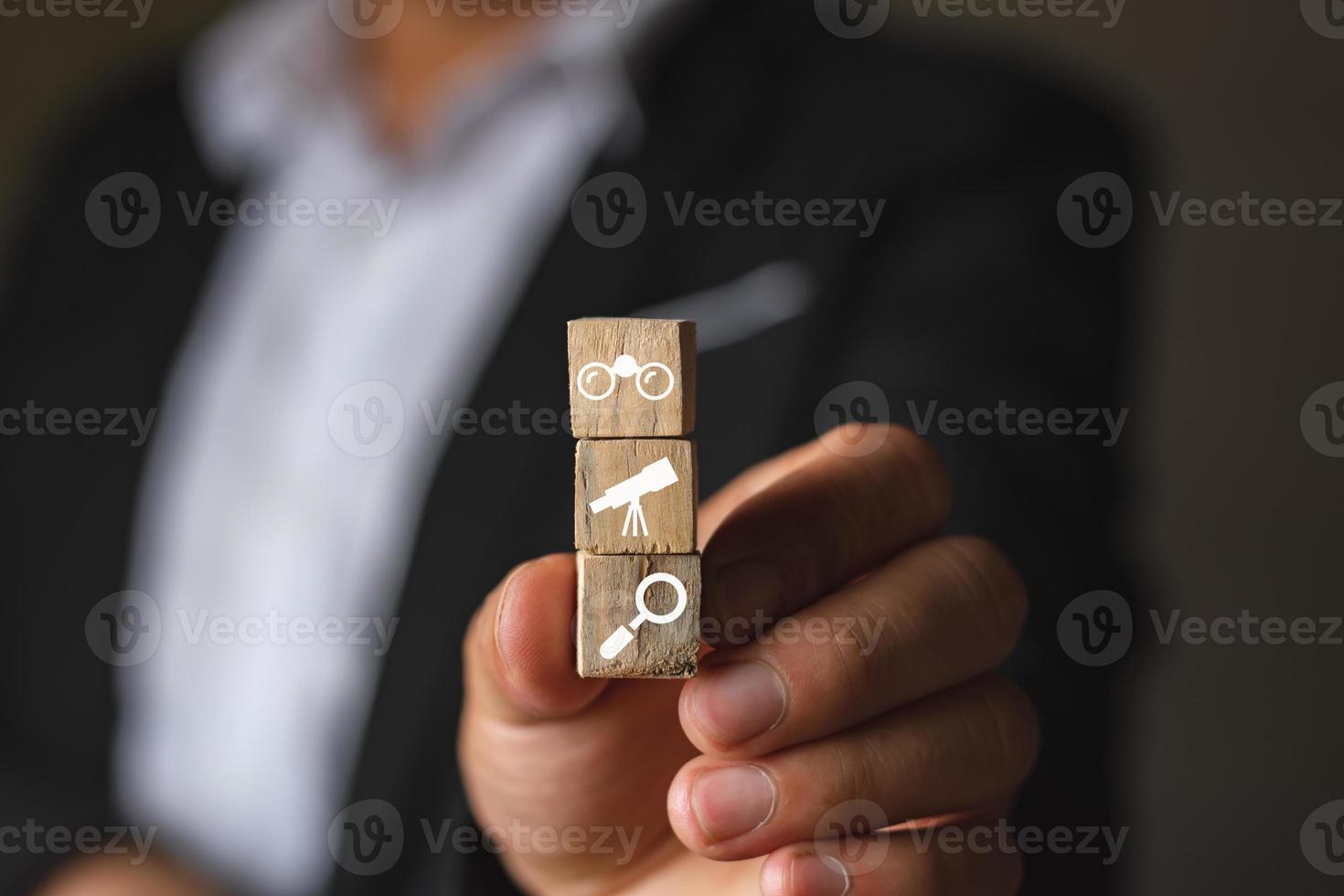 A businessman catching wood box with search icon symbol and computer graphic light, internet and searching technology, browser and data concept photo