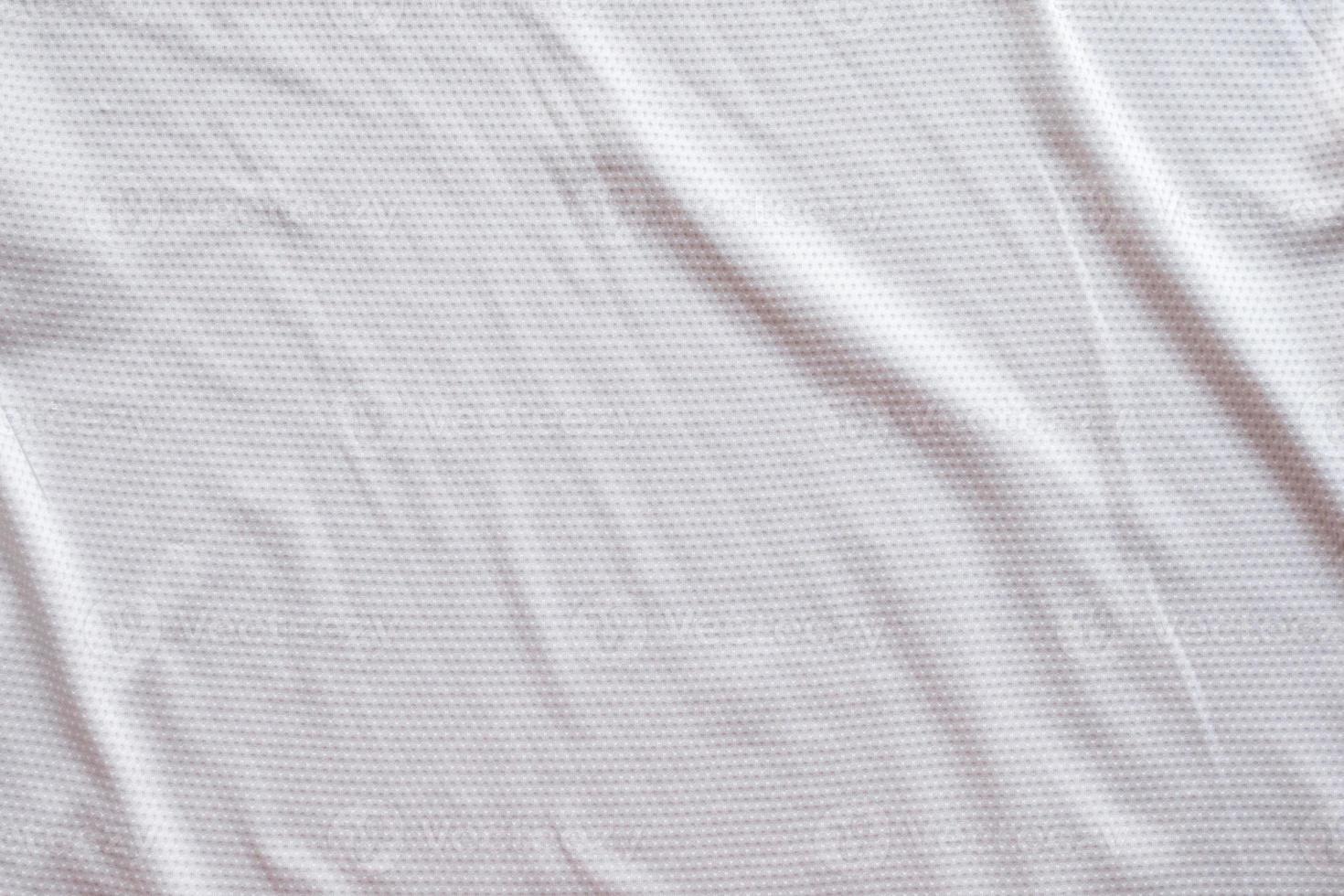 White fabric sport clothing football jersey with air mesh texture background photo