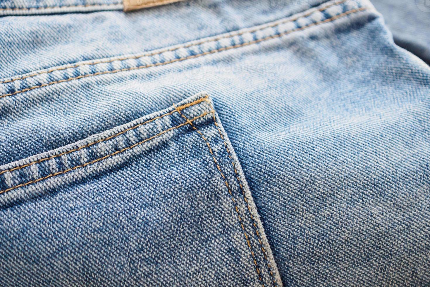 Blue denim jeans back pocket close up photo