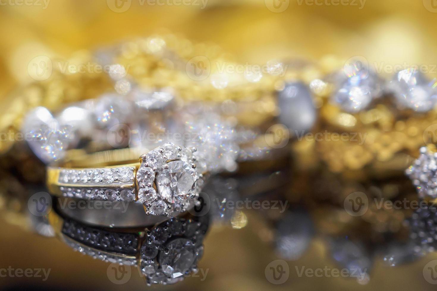 Luxury gold Jewelry diamond rings with reflection on black background photo