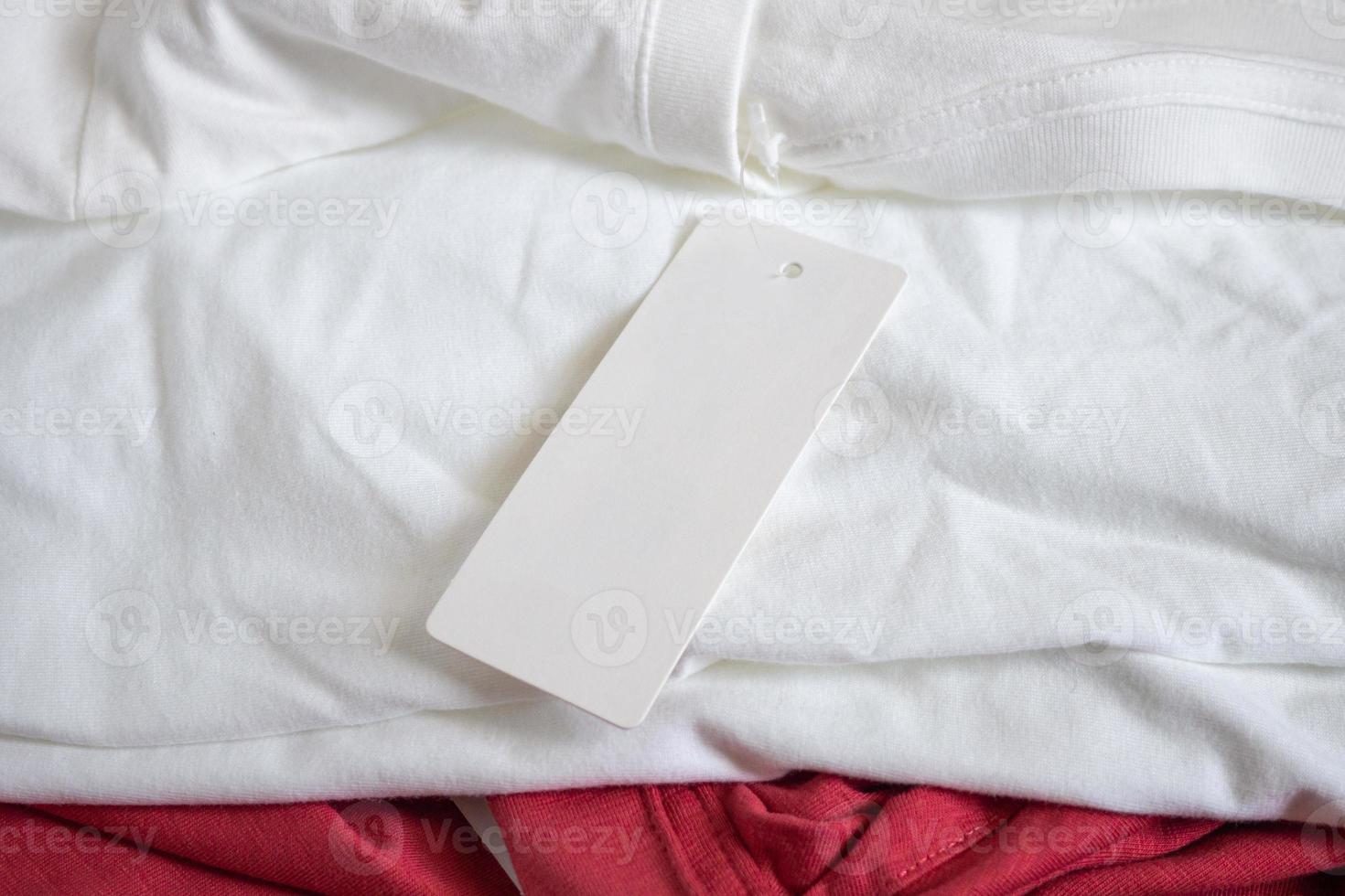Blank price tag label on white t-shirt photo