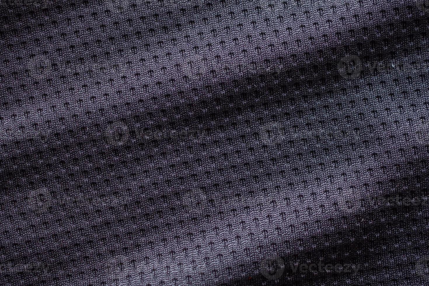 Black fabric sport clothing football jersey with air mesh texture background photo