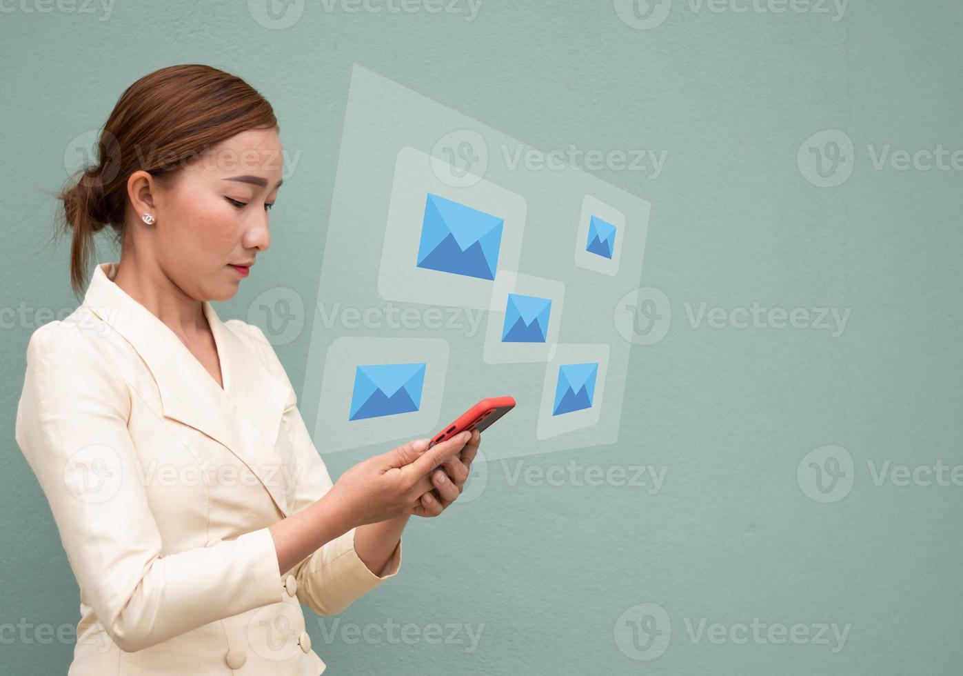 A business women check email on the mobile phone, email blue icon virtual screen, media and connection concept copy space photo