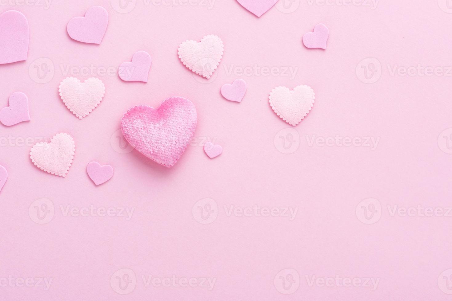 Pink heart on paper background with copy space for love wedding or valentines day photo