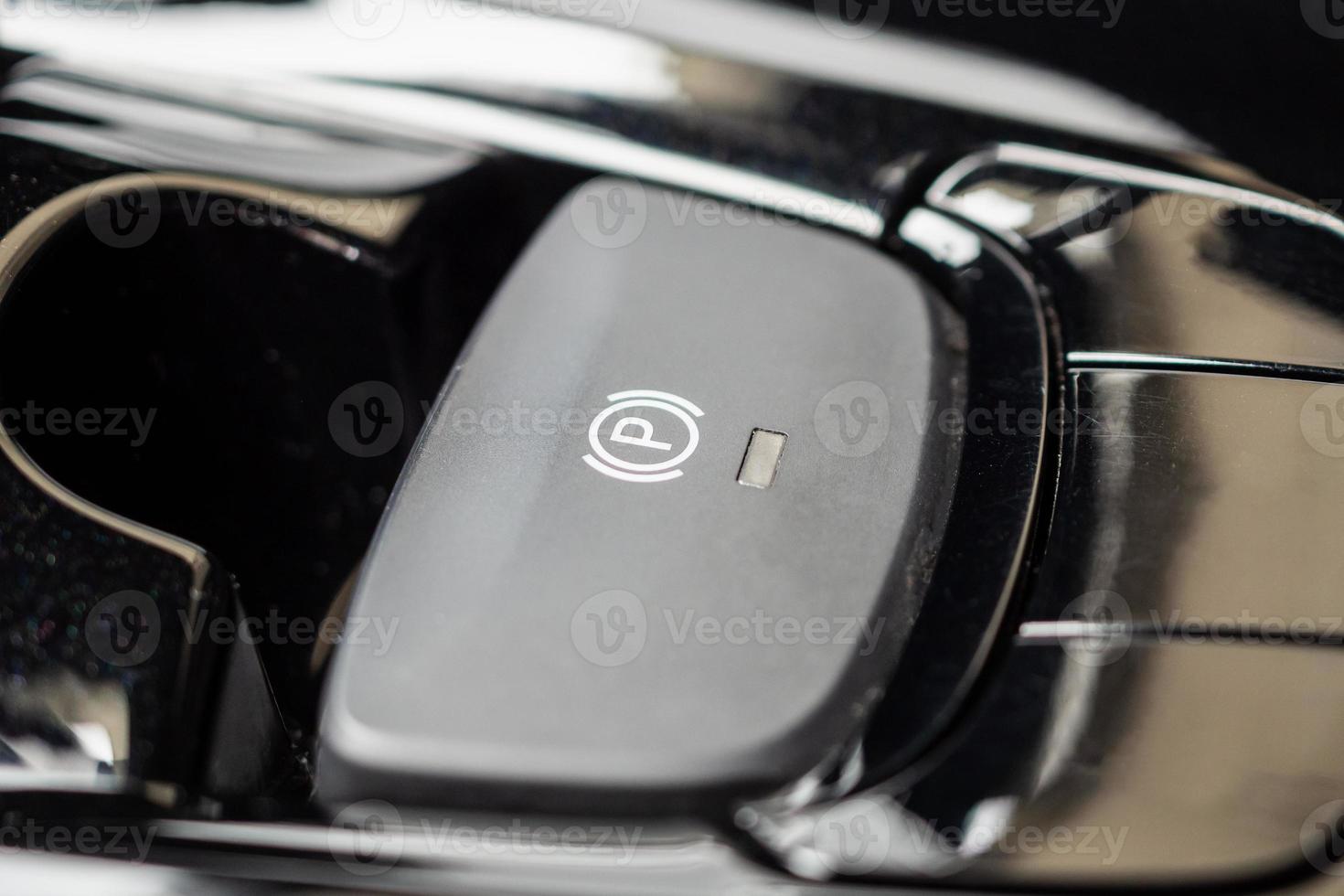 electronic handbrake button in luxury modern car photo