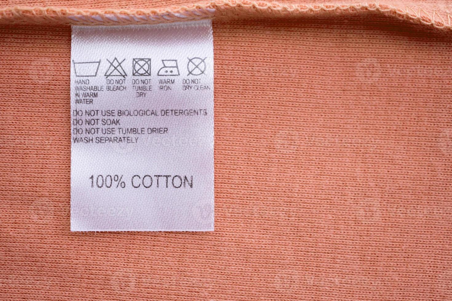 White laundry care washing instructions clothes label on cotton shirt photo