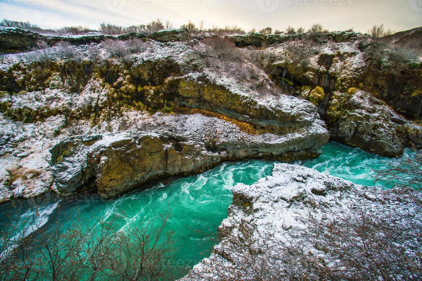 Hraunfossar, a waterfall formed by rivulets streaming over Hallmundarhraun, a lava field from volcano lying under the glacier Langjokull, and pour into the Hvita river, Iceland photo