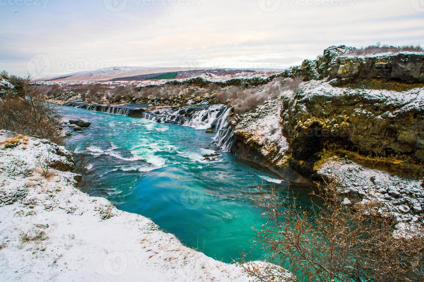 Hraunfossar, a waterfall formed by rivulets streaming over Hallmundarhraun, a lava field from volcano lying under the glacier Langjokull, and pour into the Hvita river, Iceland photo