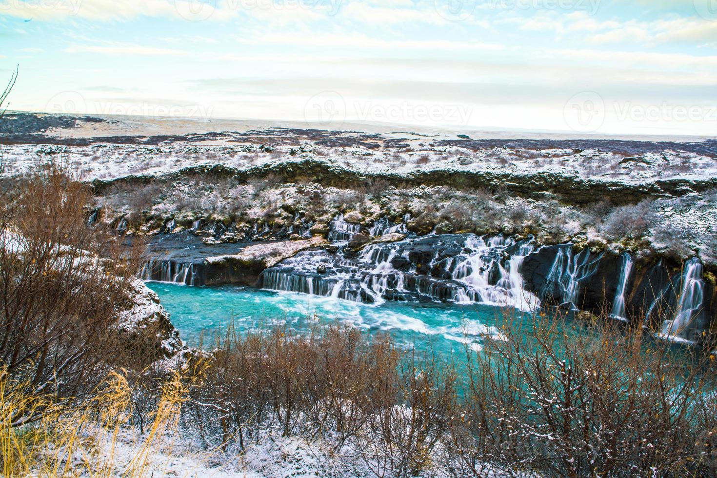Hraunfossar, a waterfall formed by rivulets streaming over Hallmundarhraun, a lava field from volcano lying under the glacier Langjokull, and pour into the Hvita river, Iceland photo