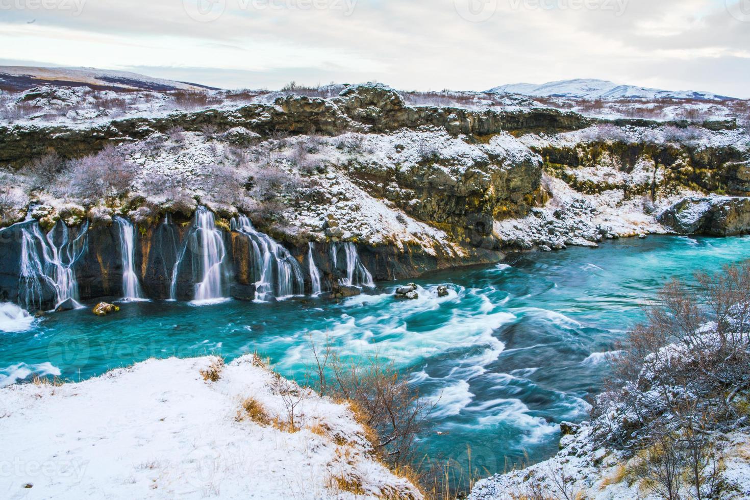 Hraunfossar, a waterfall formed by rivulets streaming over Hallmundarhraun, a lava field from volcano lying under the glacier Langjokull, and pour into the Hvita river, Iceland photo