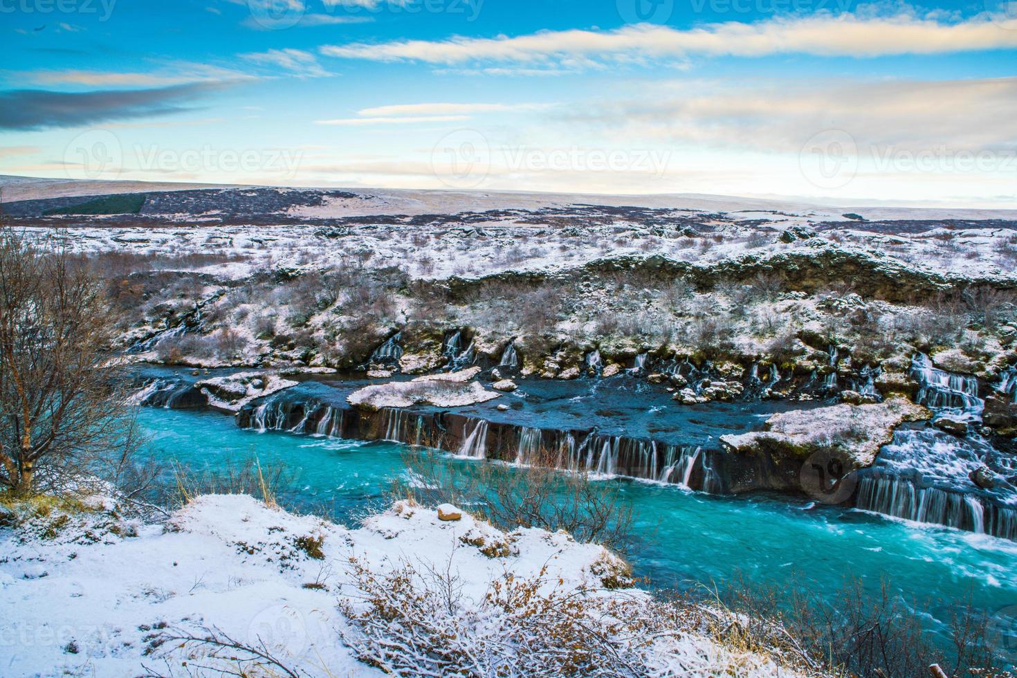 Hraunfossar, a waterfall formed by rivulets streaming over Hallmundarhraun, a lava field from volcano lying under the glacier Langjokull, and pour into the Hvita river, Iceland photo