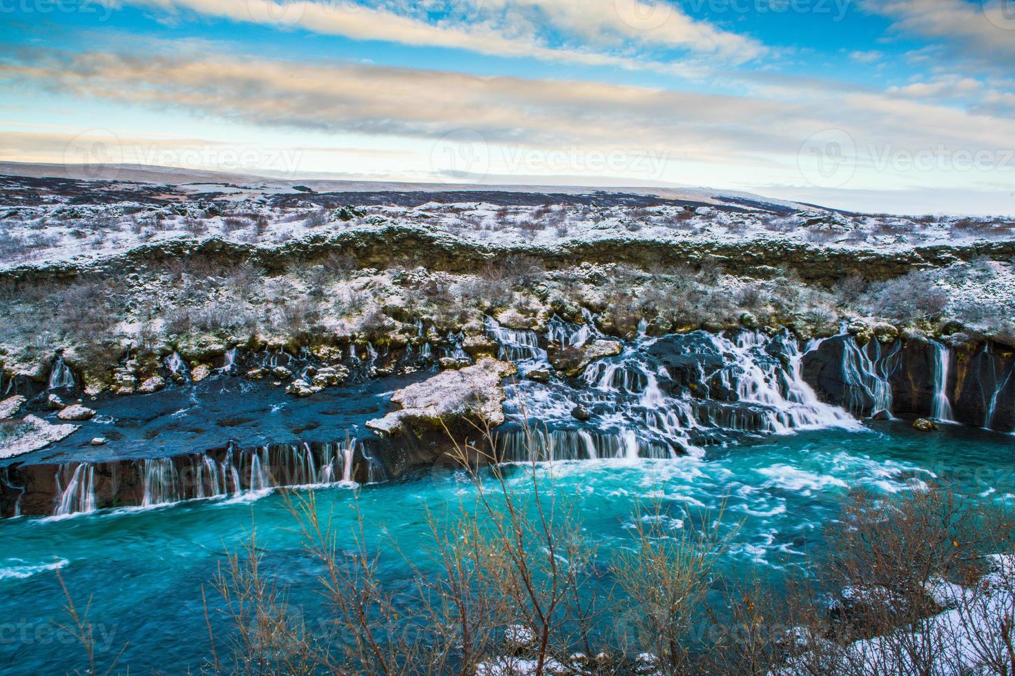 Hraunfossar, a waterfall formed by rivulets streaming over Hallmundarhraun, a lava field from volcano lying under the glacier Langjokull, and pour into the Hvita river, Iceland photo