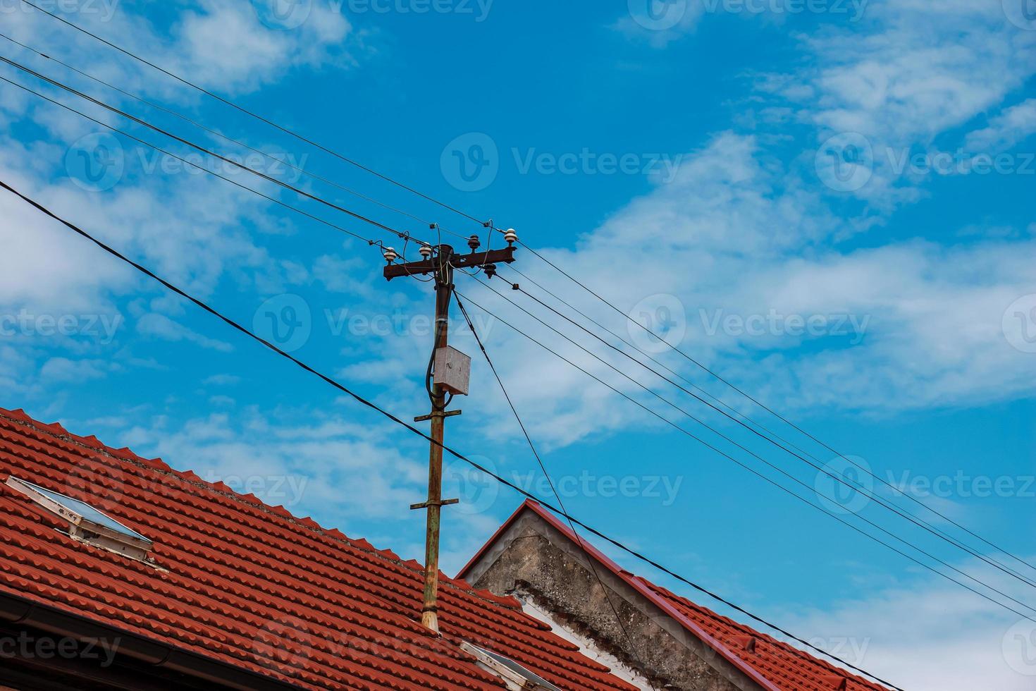 Power lines on the roof of the house. photo