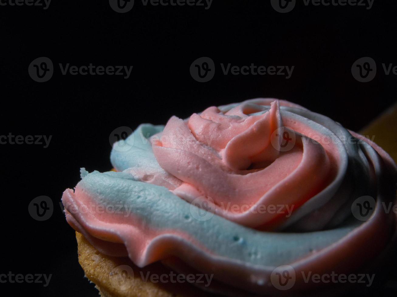 Texture of a cream of a cupcake, black background photo