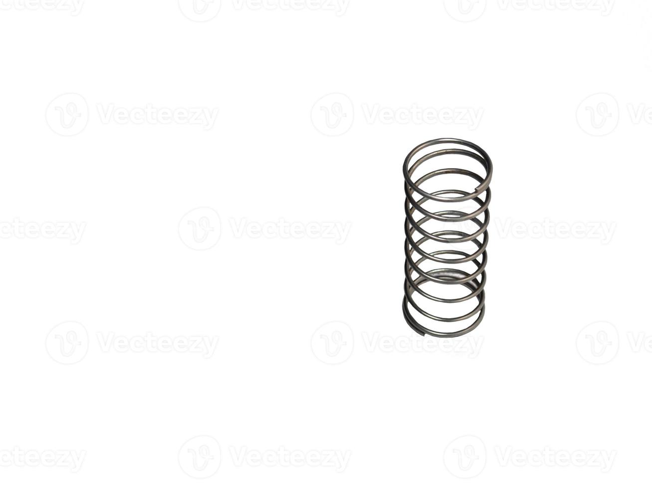 Metal spring on a white background. Mechanism element. photo