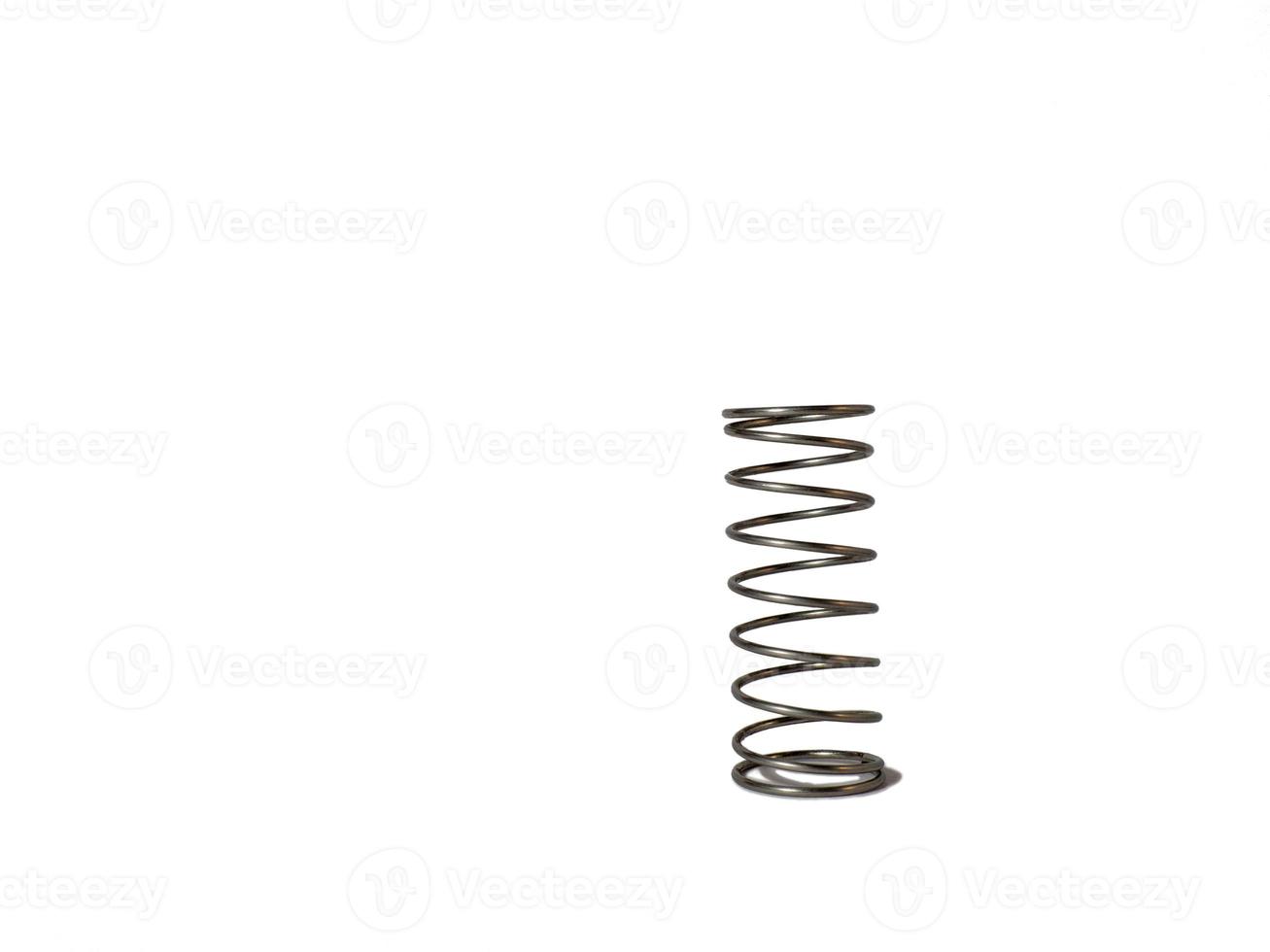 Metal spring on a white background. Mechanism element. photo