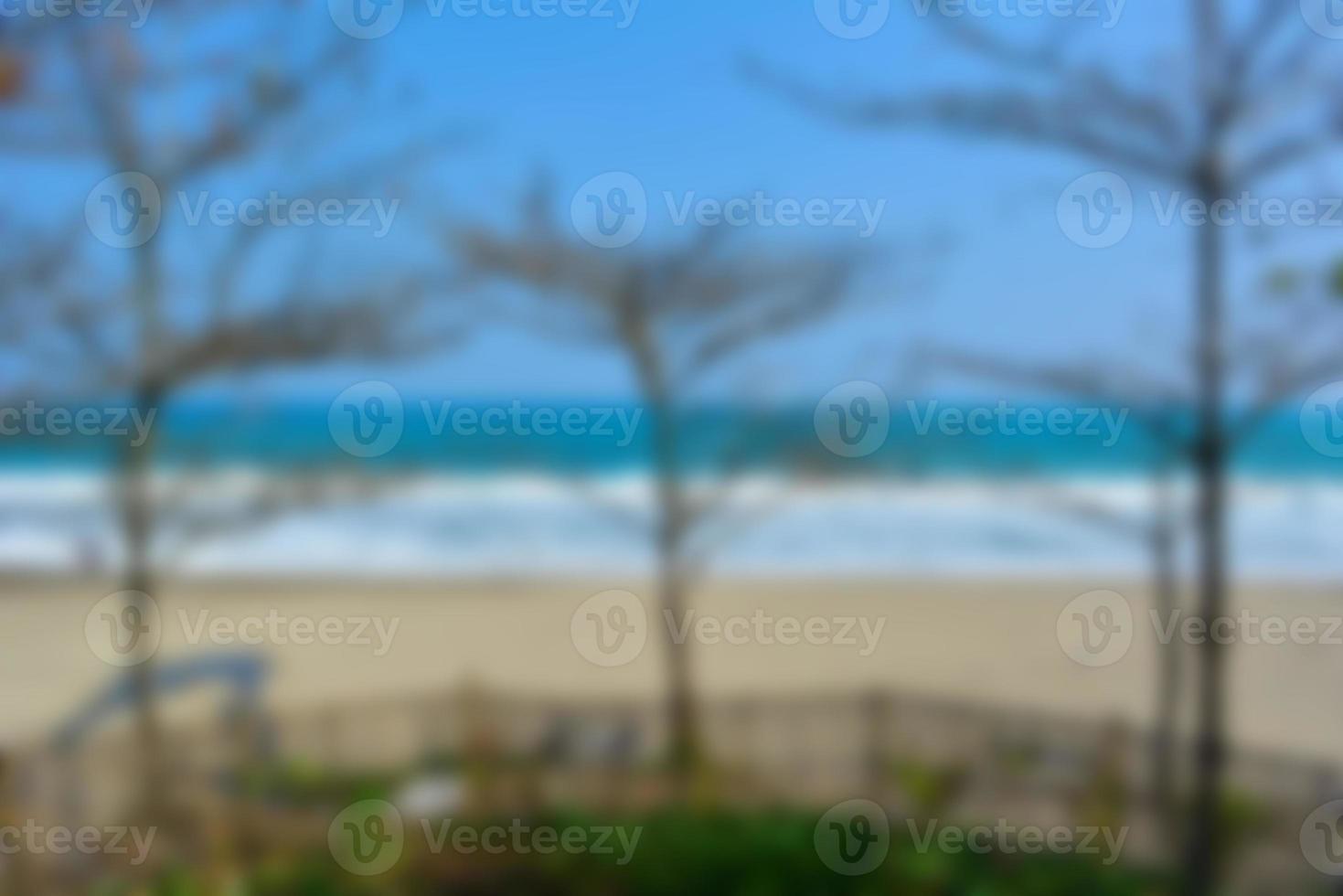 Blurred background, view tropical beach with sun light wave abstract background. Travel concept. photo