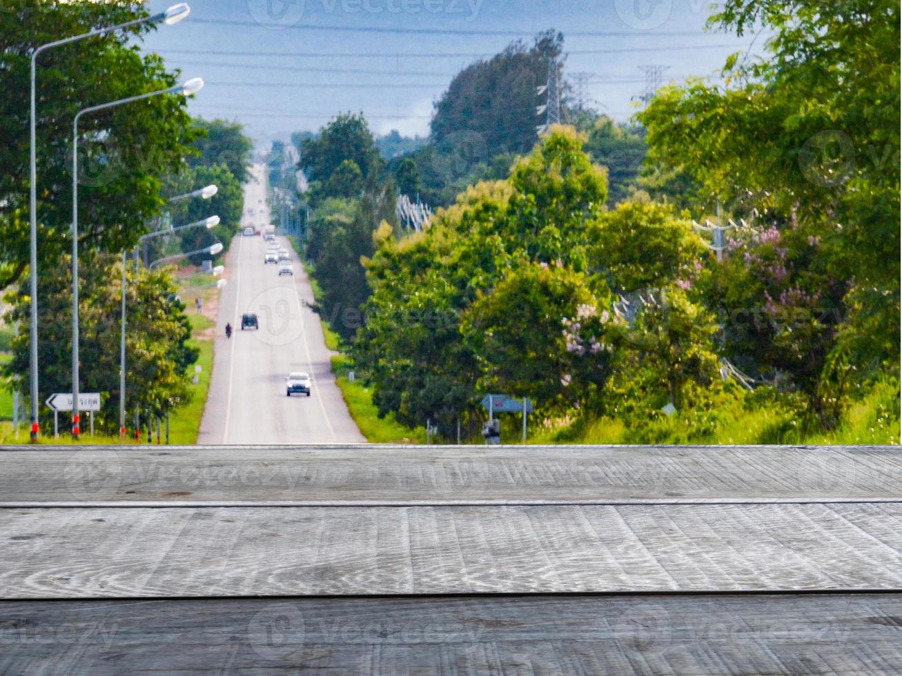 Old wooden table shelf in the background scenery  A highway surrounded by greenery photo