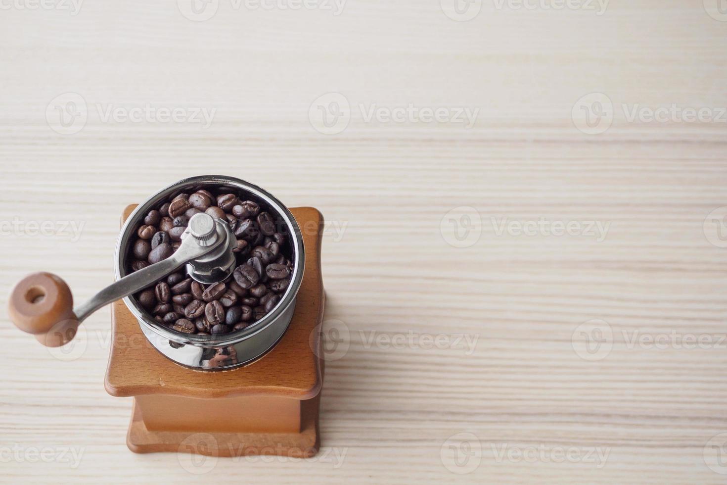 Vintage manual coffee grinder with roasted coffee beans photo