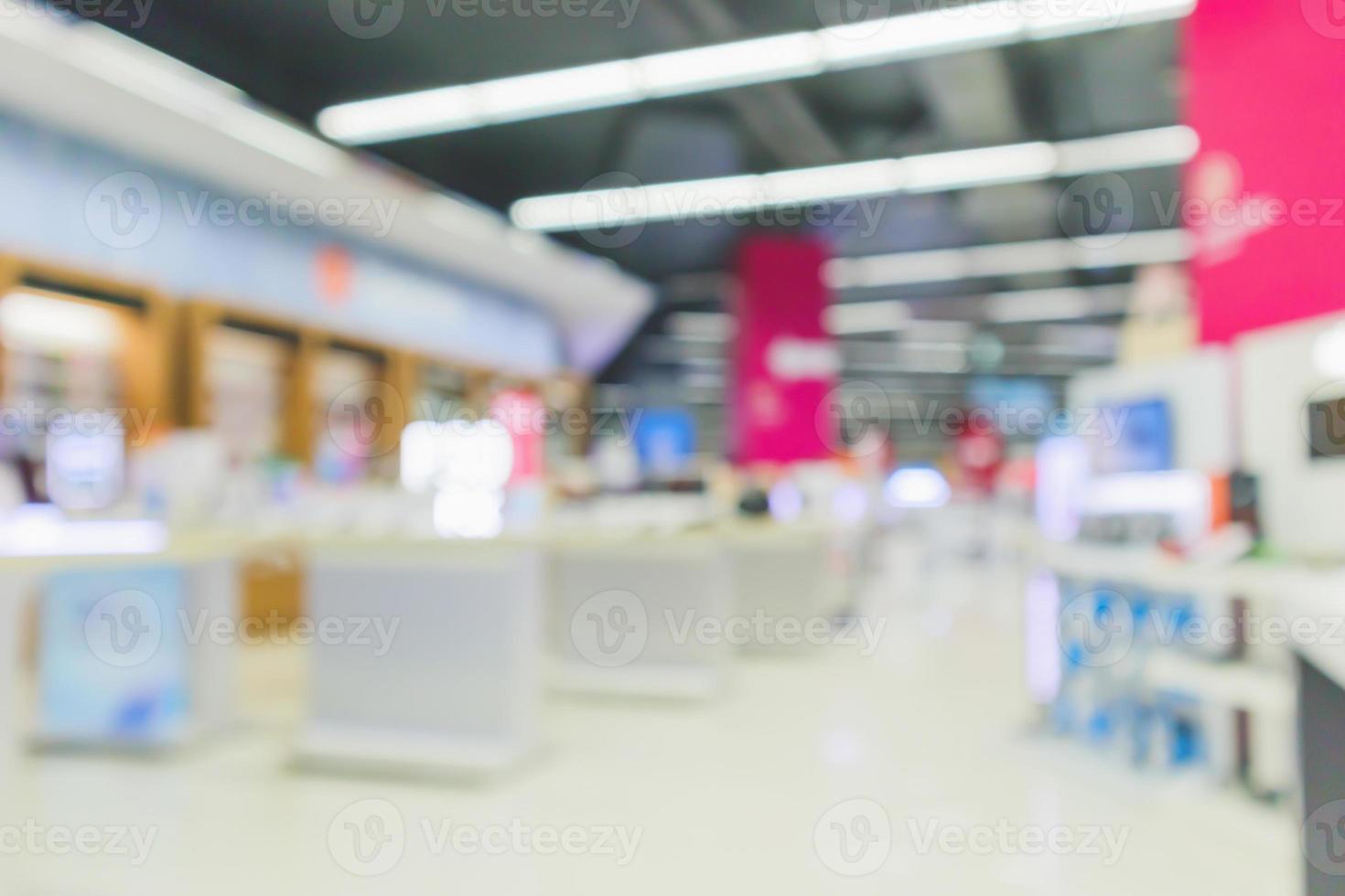 mobile phone in electronic store interior with customer abstract blurred background photo