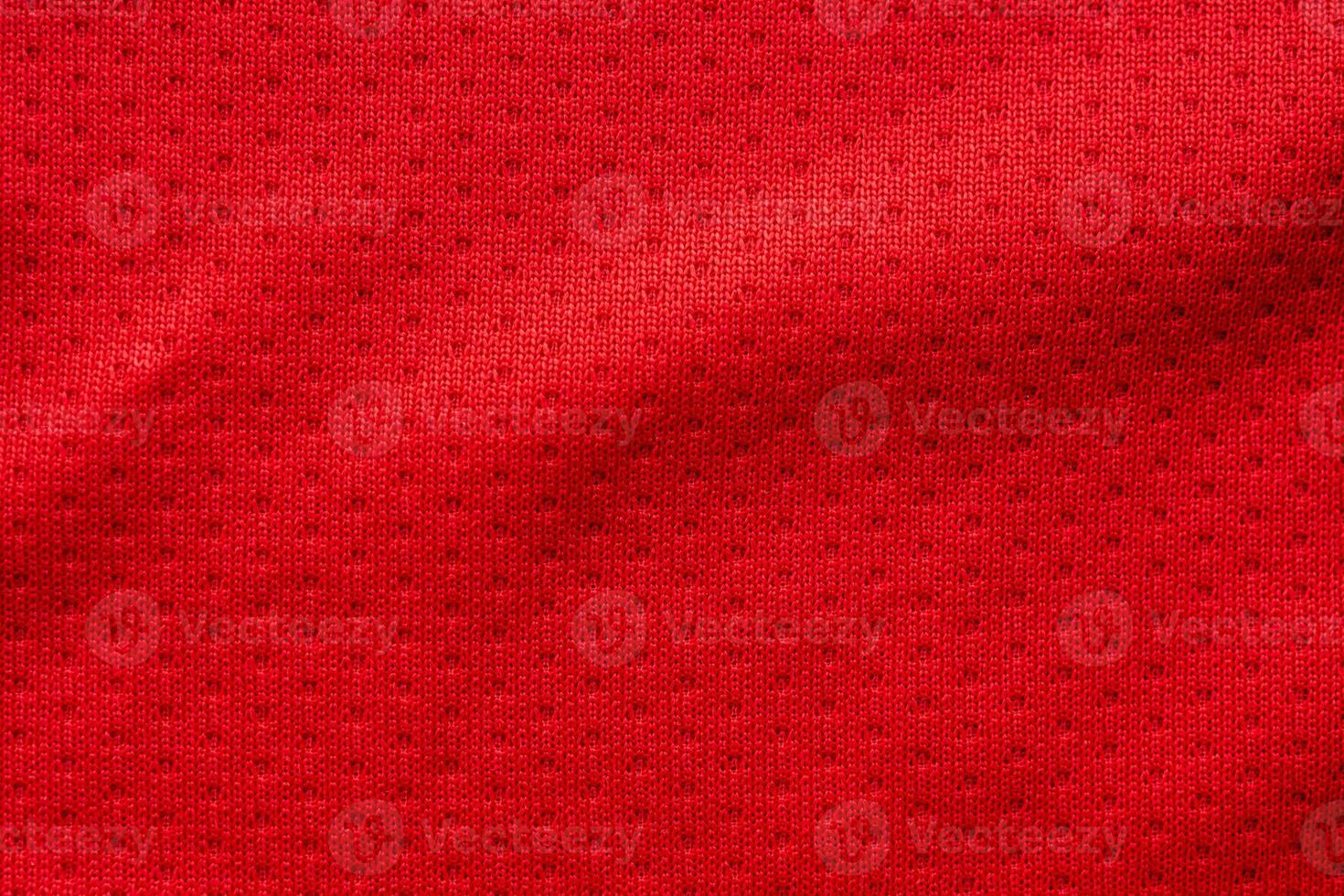 Red fabric sport clothing football jersey with air mesh texture background photo