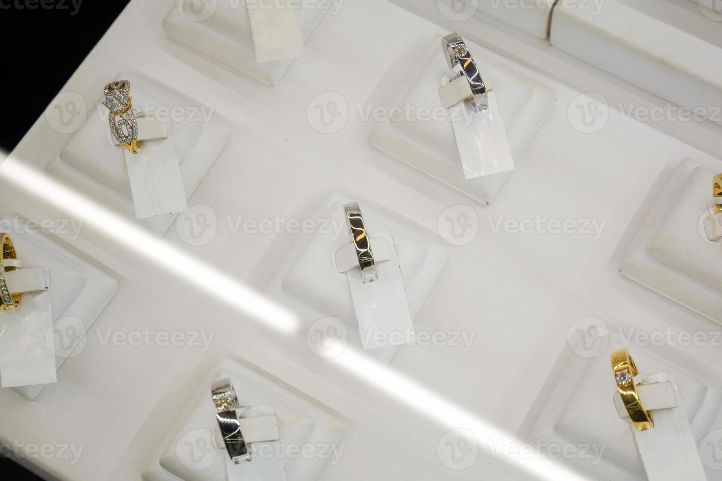 Gold jewelry diamond rings show in luxury retail store window display showcase photo