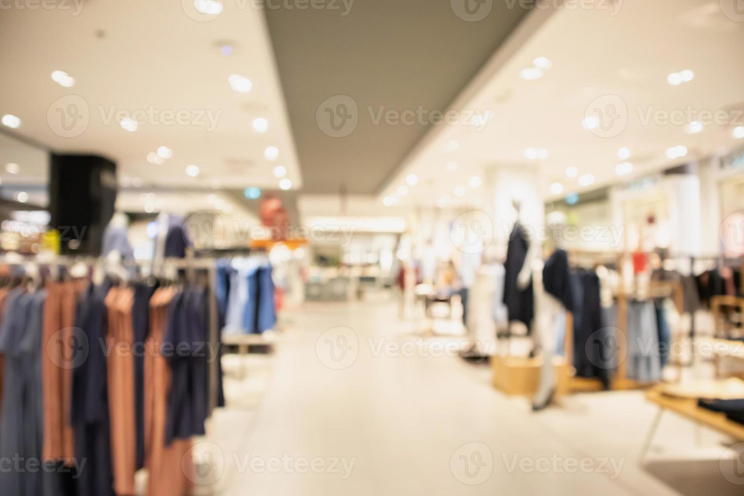 Woman fashionable boutique clothing store window display in shopping mall blur defocused background photo