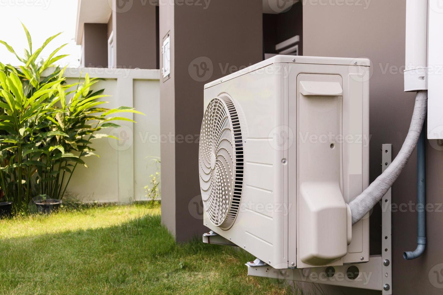 Air conditioner compressor outdoor unit installed outside the house photo
