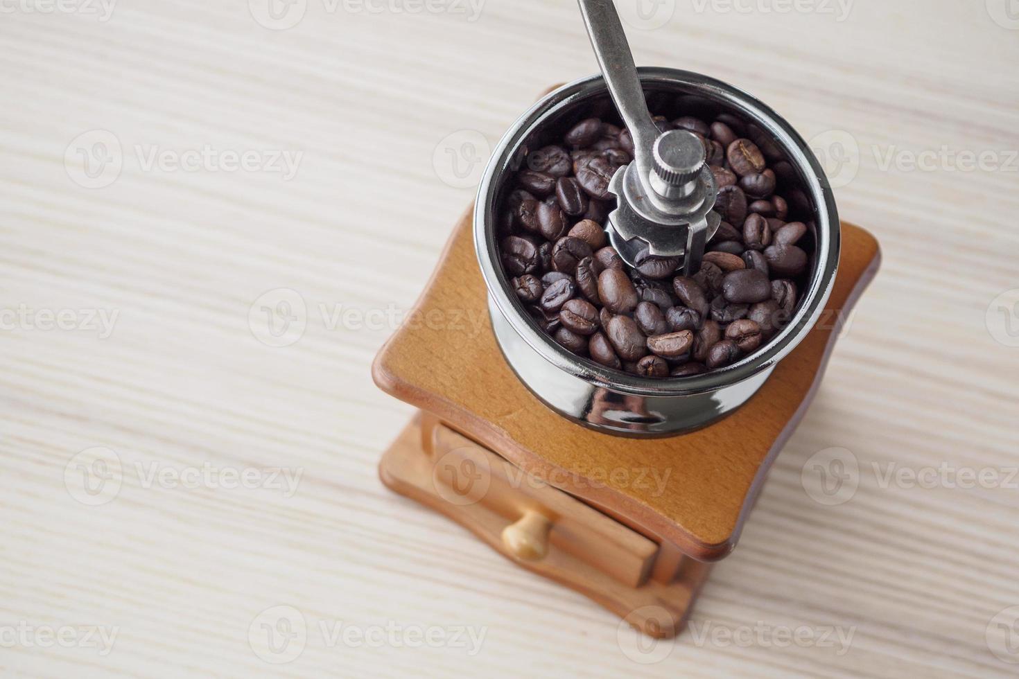Vintage manual coffee grinder with roasted coffee beans photo