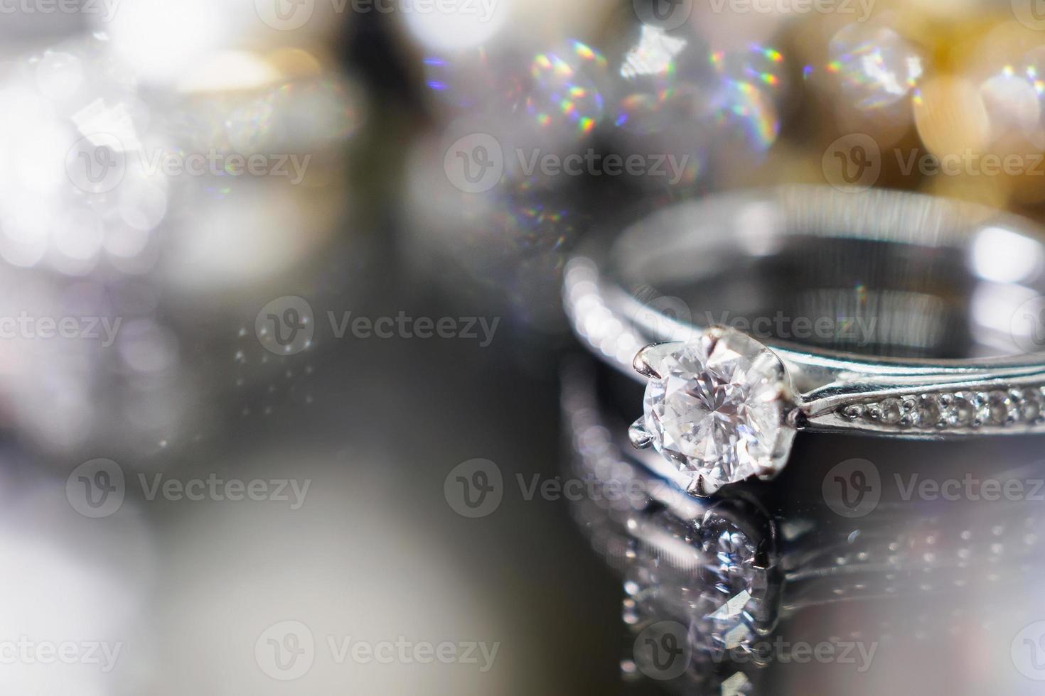 Jewelry diamond rings with reflection on black background photo