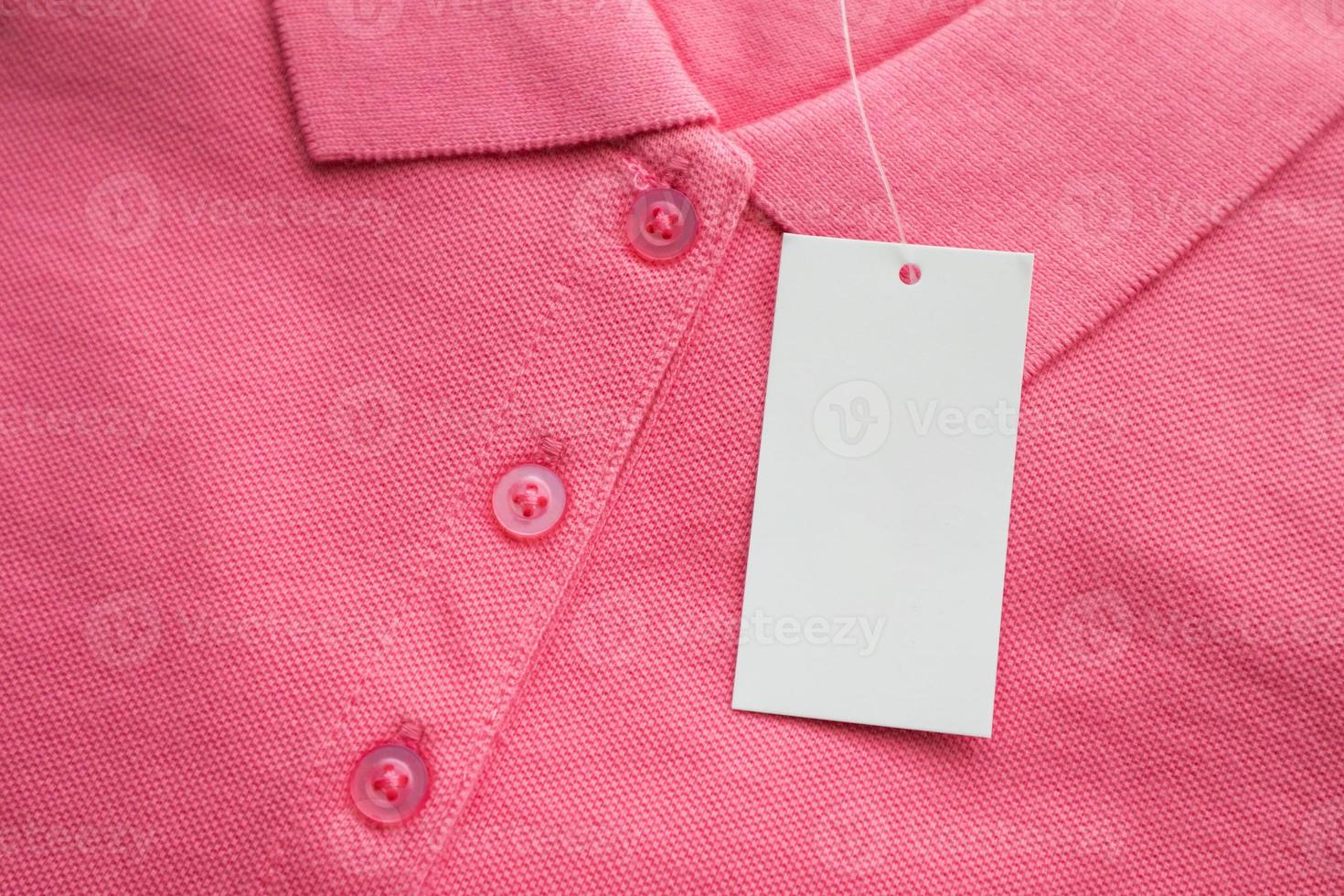 Blank white clothes tag label on new shirt photo