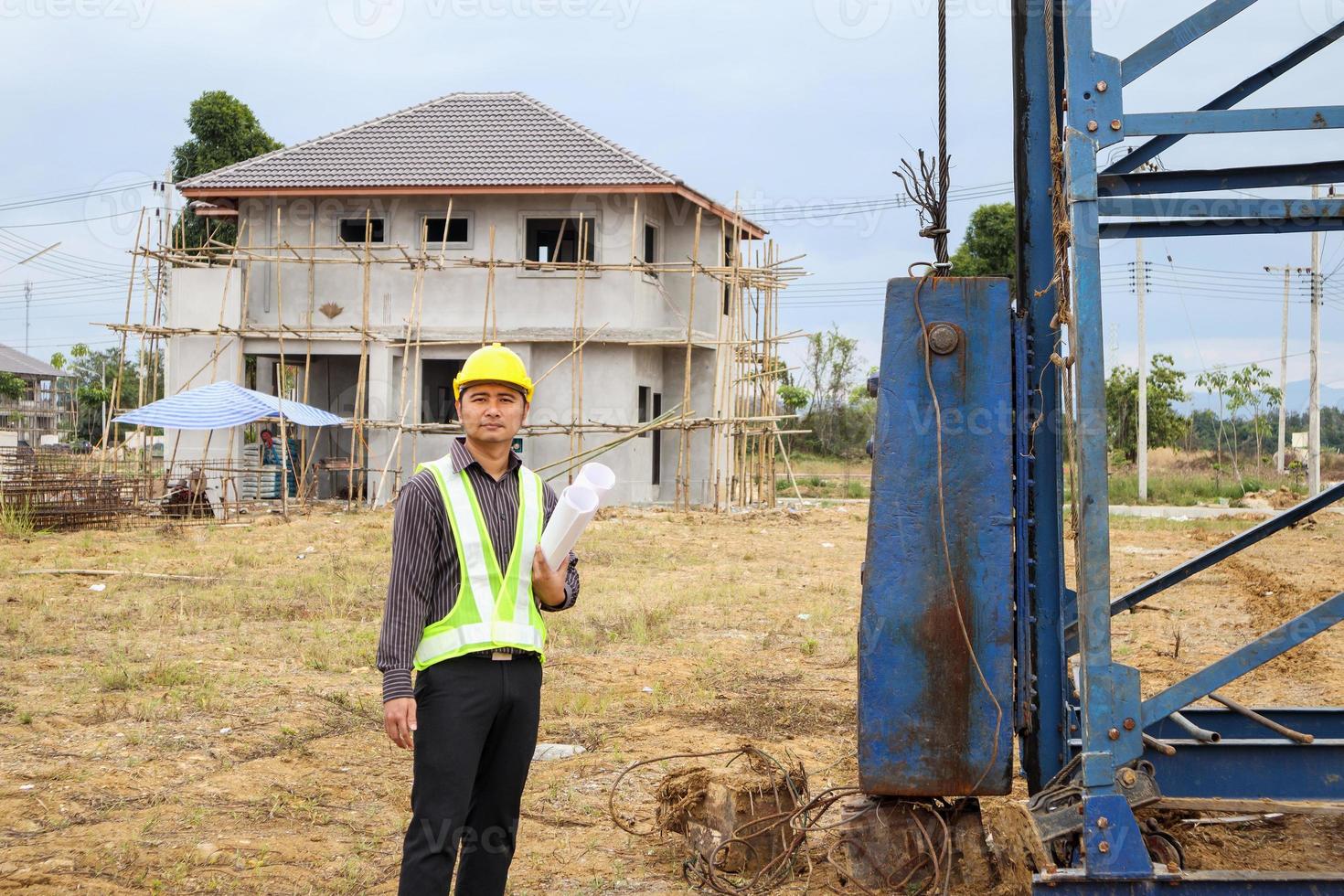 Asian business man construction engineer worker at house building site photo