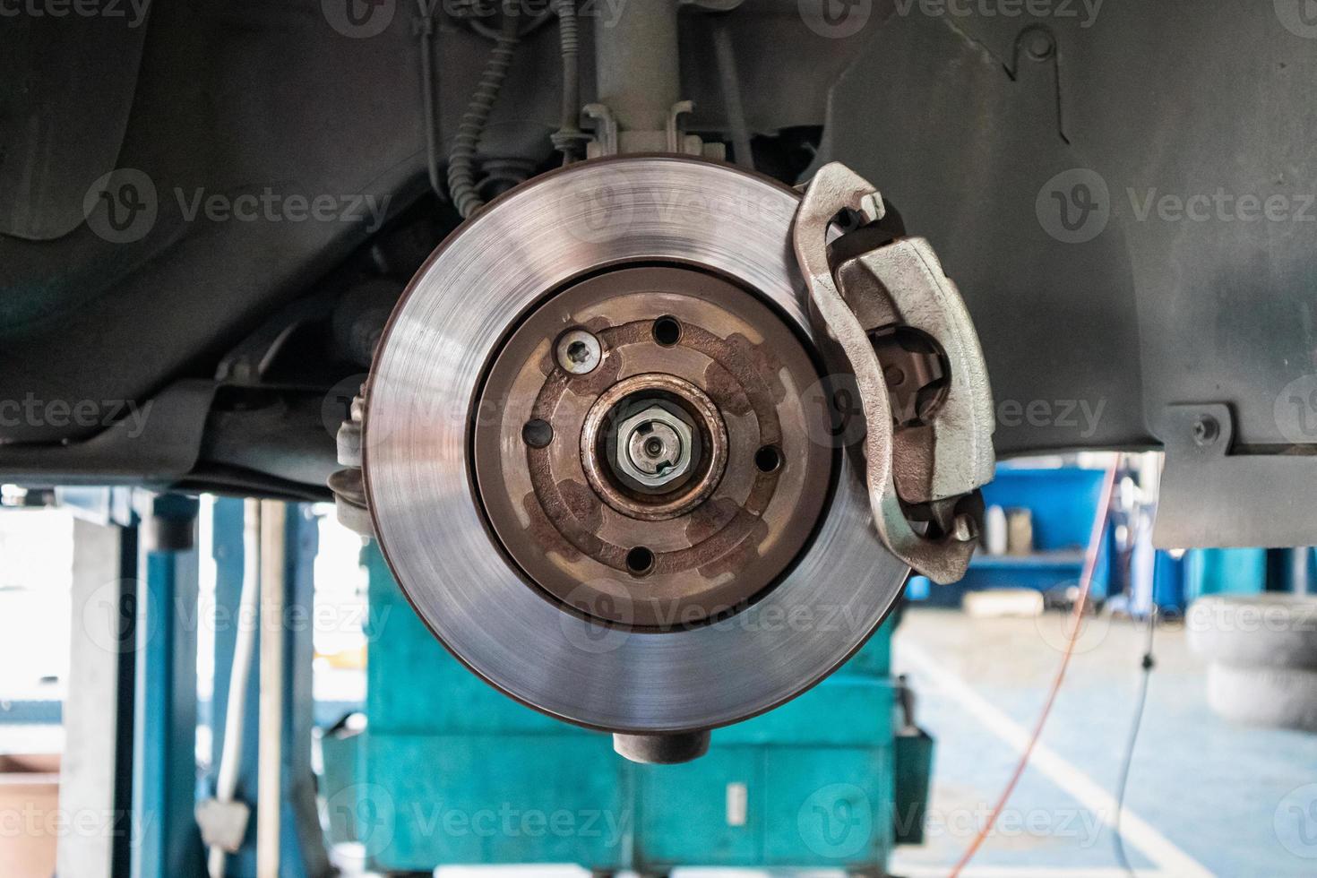 Close up disc brake at car service workshop photo