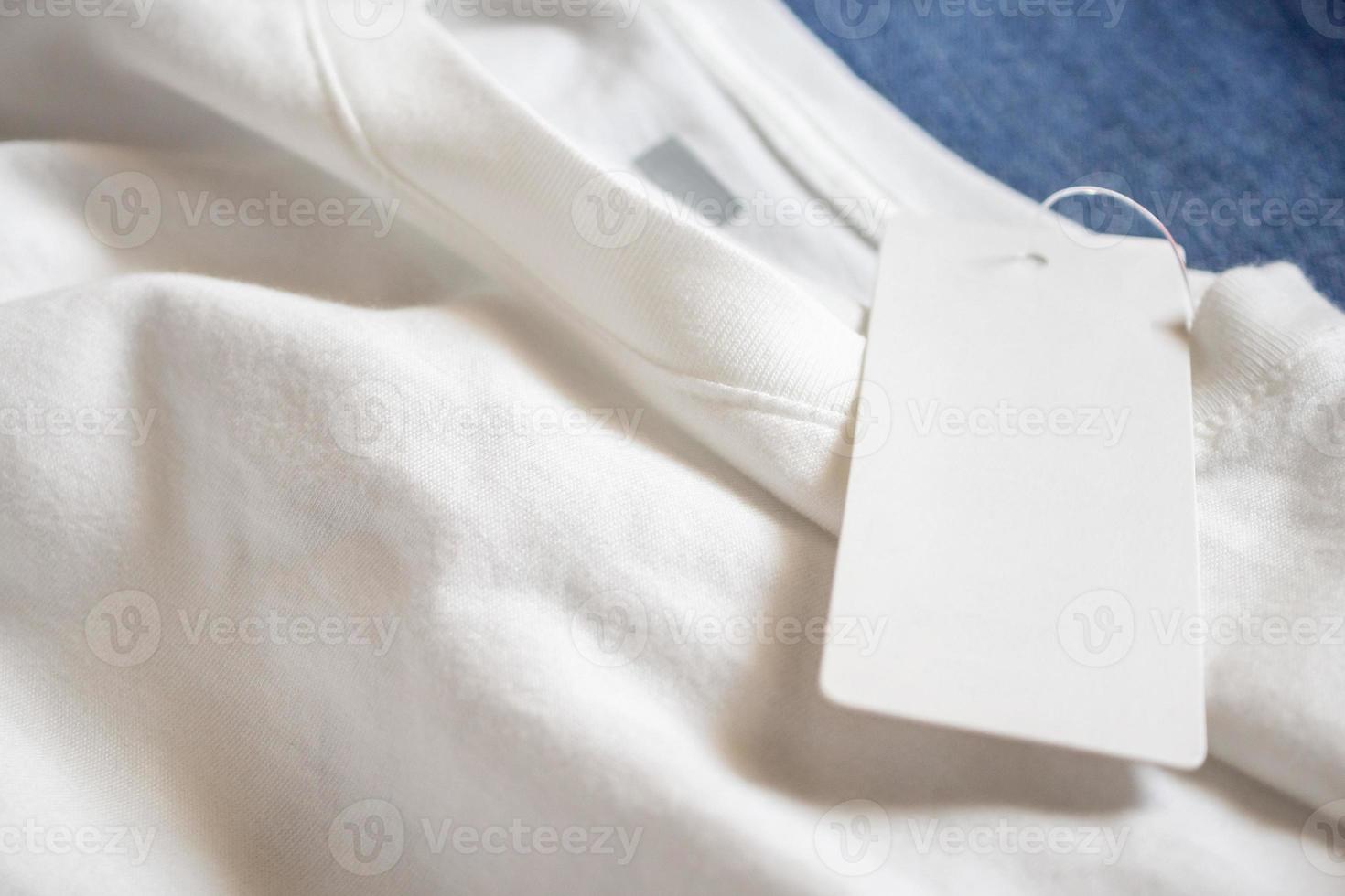 Blank price tag label on white t-shirt photo