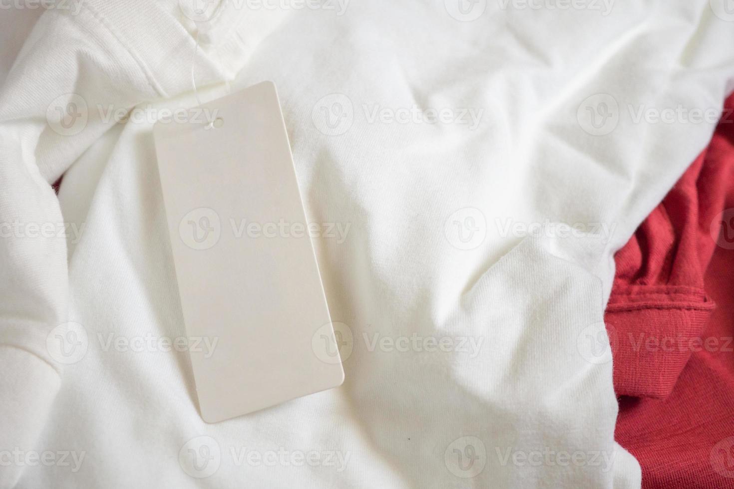 Blank price tag label on white t-shirt photo